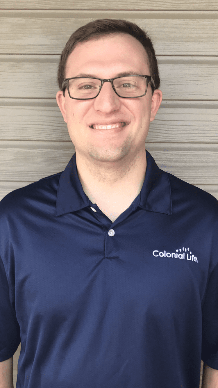 Person wearing a navy blue Colonial Life polo shirt.