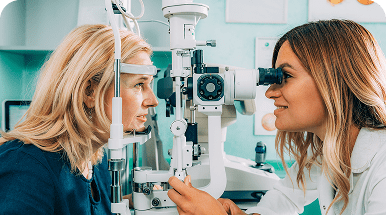 Optometrist examining patient's eyes