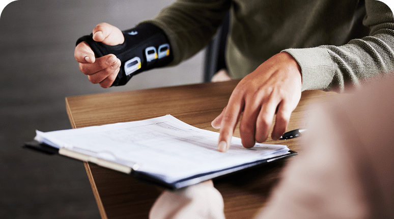 Arm brace wearer pointing at paperwork
